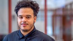 Ashon Lanada on stairs in school of business